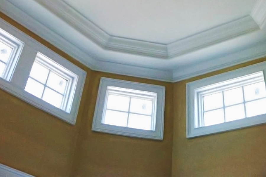 windows on a wall and custom trim work on the ceiling
