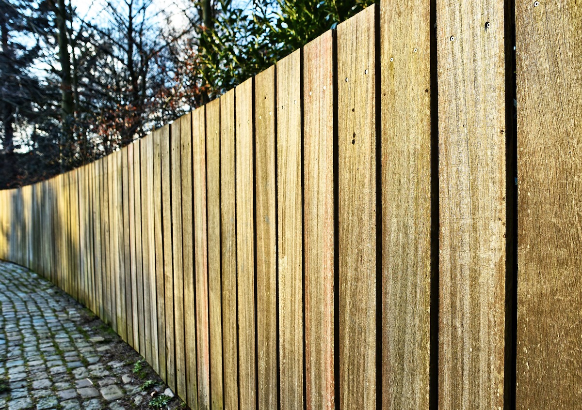 wooden fence aligned on a pathway outside